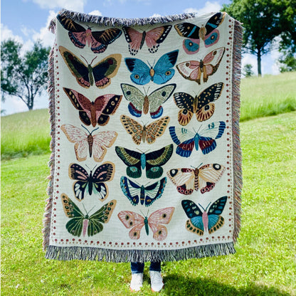 Cozy woven throw blanket with vibrant hand-illustrated butterflies. Brings joyful colors and charm to nurseries, dorms, and reading nooks.
