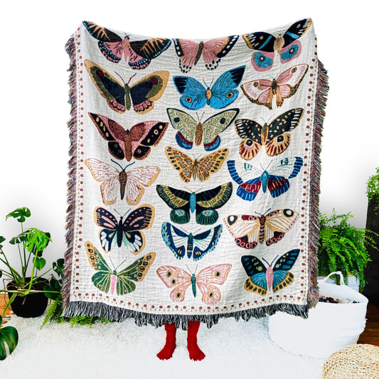 Cozy woven throw blanket with vibrant hand-illustrated butterflies. Brings joyful colors and charm to nurseries, dorms, and reading nooks.